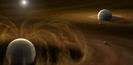 Jupiter (lower left) has a strong magnetic field which creates a cavity in its circumplanetary disk; Saturn (upper right) lacks a strong magnetic field so its circumplanetary disk evolves without a cavity. Image credit: Yuri I. Fujii / L-INSIGHT / Kyoto University / Shinichiro Kinoshita.
