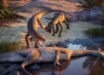 Eosphorosuchus lacrimosa (left) is disturbed by Hesperosuchus agilis (right) near a Coelophysis carcass at what will become modern-day Ghost Ranch, New Mexico, the United States. Image credit: Julio Lacerda.
