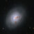 This Hubble image reveals the lenticular galaxy NGC 1266; reddish-brown clumps and filaments of dust partially obscure the galaxy’s full face, while red, blue, and orange light from distant galaxies shines through its diffuse outer regions and dots the inky-black background. Image credit: NASA / ESA / K. Alatalo, STScI / G. Kober, NASA & Catholic University of America.