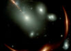 This Webb image shows the highly distorted red galaxy MRG-M0138 seen through a foreground cluster of galaxies (white sources). Image credit: NASA / ESA / CSA / Webb.