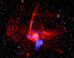 This composite image contains X-rays from Chandra and XMM-Newton missions (shown in blue) as well as radio data from the MeerKAT telescope (shown in red) in South Africa. These have been combined with an optical image from the Pan-STARRS telescopes in Hawai’i (red, green, and blue). Image credit: NASA / CXC / UCLA / Zhu et al. / ESA / XMM-Newton / PanSTARRS / MeerKAT / CSA / STScI / SAO / L. Frattare & P. Edmonds.