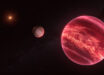 This illustration shows the stellar system CD-35 2722, with the newly found exomoon at the center; the star has about half the mass of our Sun, and it is orbited by a brown dwarf, the reddish-brown object seen here in the foreground (right). Image credit: ESO / M. Kornmesser.