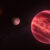 This illustration shows the stellar system CD-35 2722, with the newly found exomoon at the center; the star has about half the mass of our Sun, and it is orbited by a brown dwarf, the reddish-brown object seen here in the foreground (right). Image credit: ESO / M. Kornmesser.