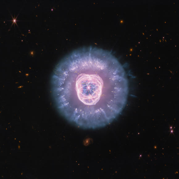 This Webb/NIRCam/MIRI image shows the Eskimo Nebula, a bipolar planetary nebula some 4,200 light-years away in the constellation of Gemini. Image credit: NASA / ESA / CSA / Webb / STScI / Alyssa Pagan, STScI.