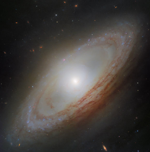 This Hubble image shows NGC 4698, a barred spiral galaxy some 55 million light-years away in the constellation of Virgo. Image credit: NASA / ESA / Hubble / D. Thilker, MAUVE-HST Team.